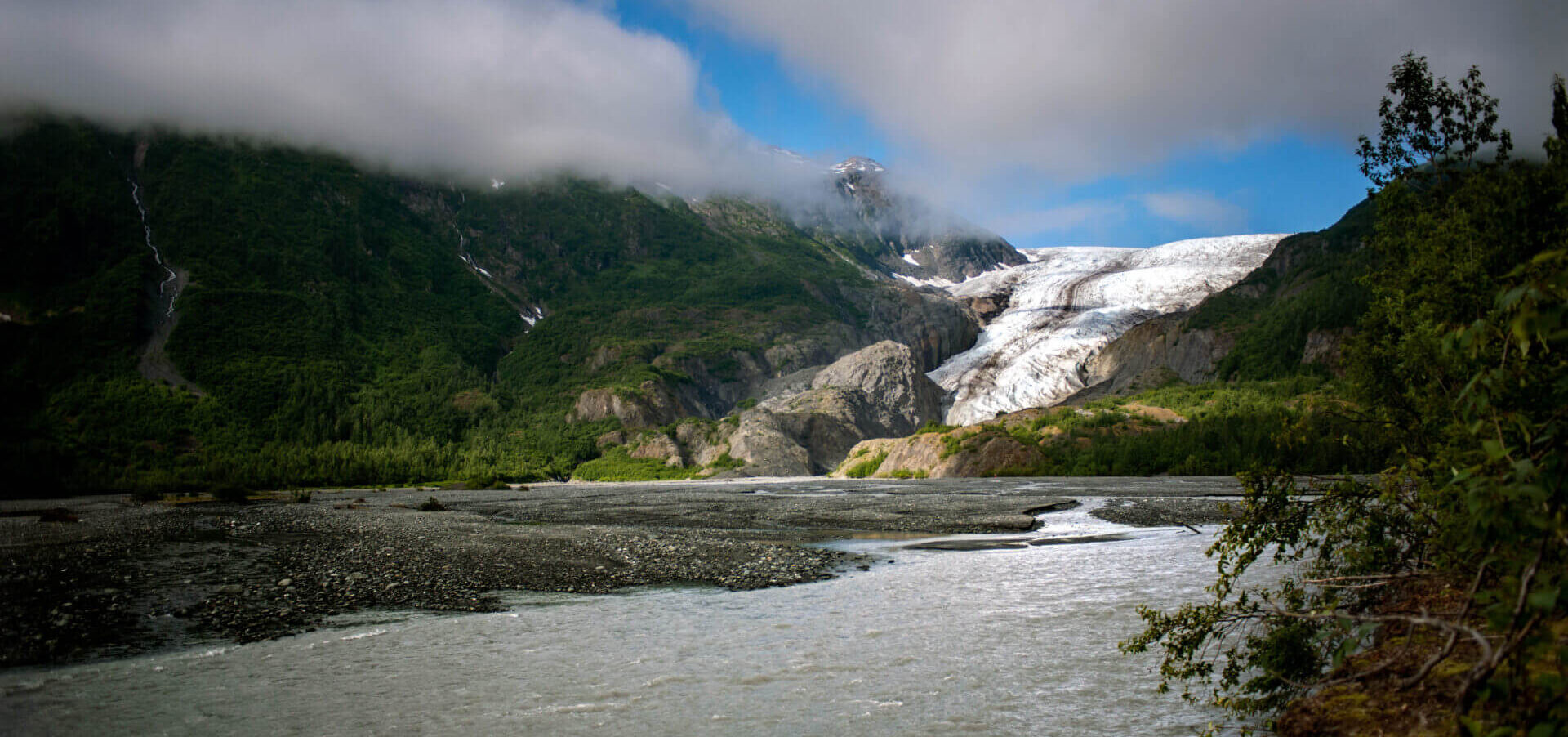 Travelers walking near Exit Glacier in Kenai Fjords National Park on a guided Alaska tour with White Raven